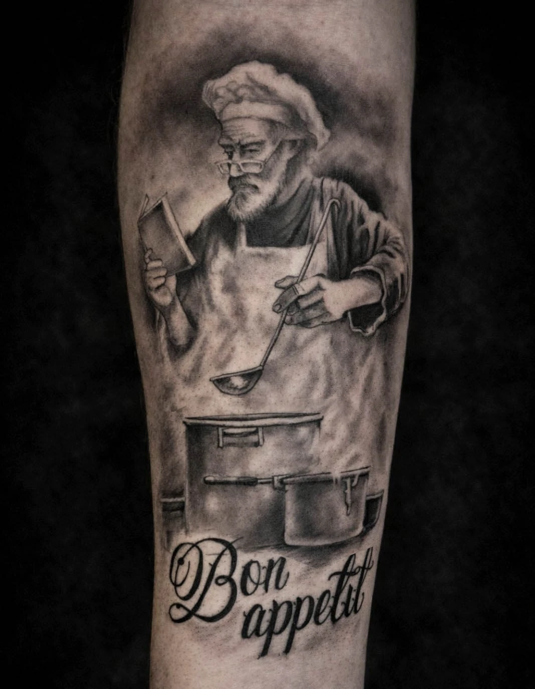 Realistic chef portrait tattoo with Bon Appetit lettering